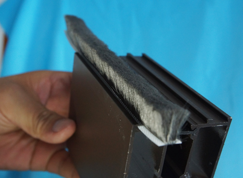 Fin seal weatherstrip fitted into an aluminium window extrusion.
