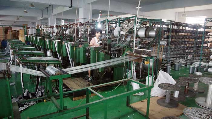Braiding machines running pile weatherstrip on the production floor